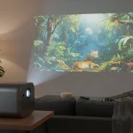 Modern portable projector displaying a movie in a cozy living room